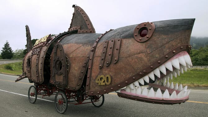 A giant steampunk shark on a bicycle.