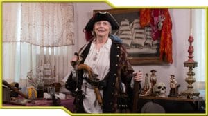 A woman in a pirate costume participating in a pirate reenactment.
