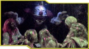 A clown in a dark room with kids at Beyond Geek.