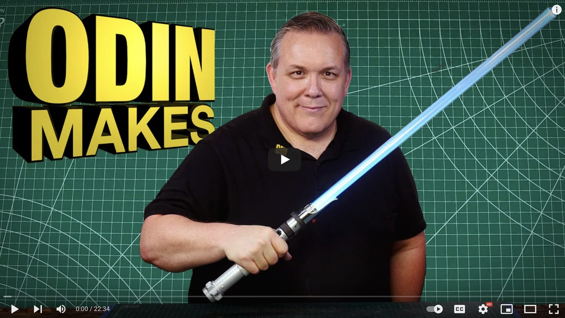 A man holds a blue lightsaber in front of a green background with white grid lines, with the text "ODIN MAKES" in large yellow letters to the left. Learn "How to Build a Lightsaber" that's combat ready with Odin Makes.