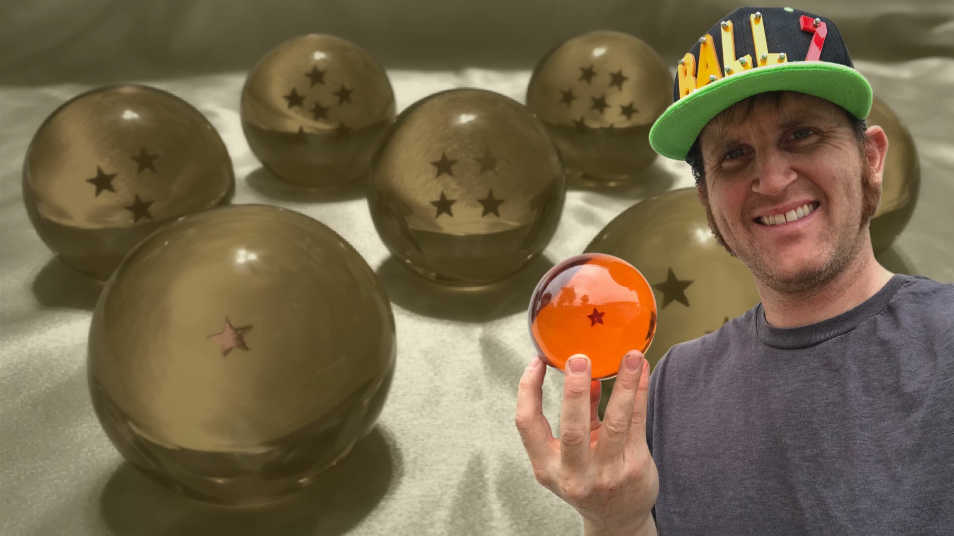A man with a hat holding a bunch of gold balls.