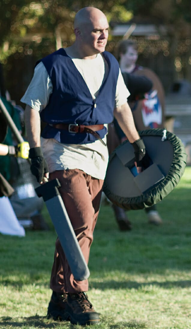 A man walking with a sword.