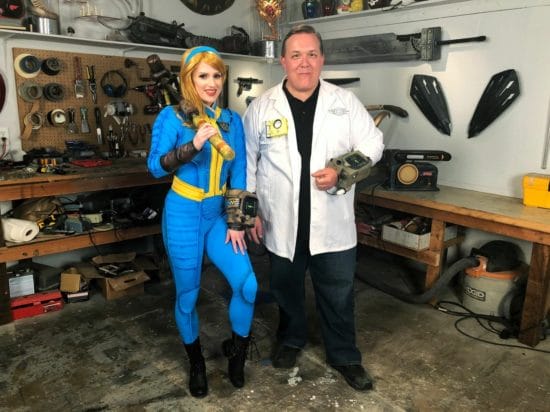 A man and a woman in a costume workshop.