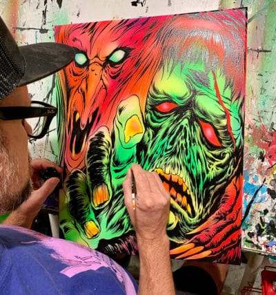 A man working on a painting of a zombie in the Art of Skinner Podcast.