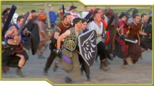 A crowd rushes into medieval combat