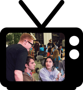 A group of people sitting around a television.