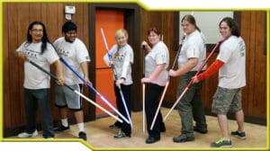 A group of people from Saber Guild posing with lightsabers.