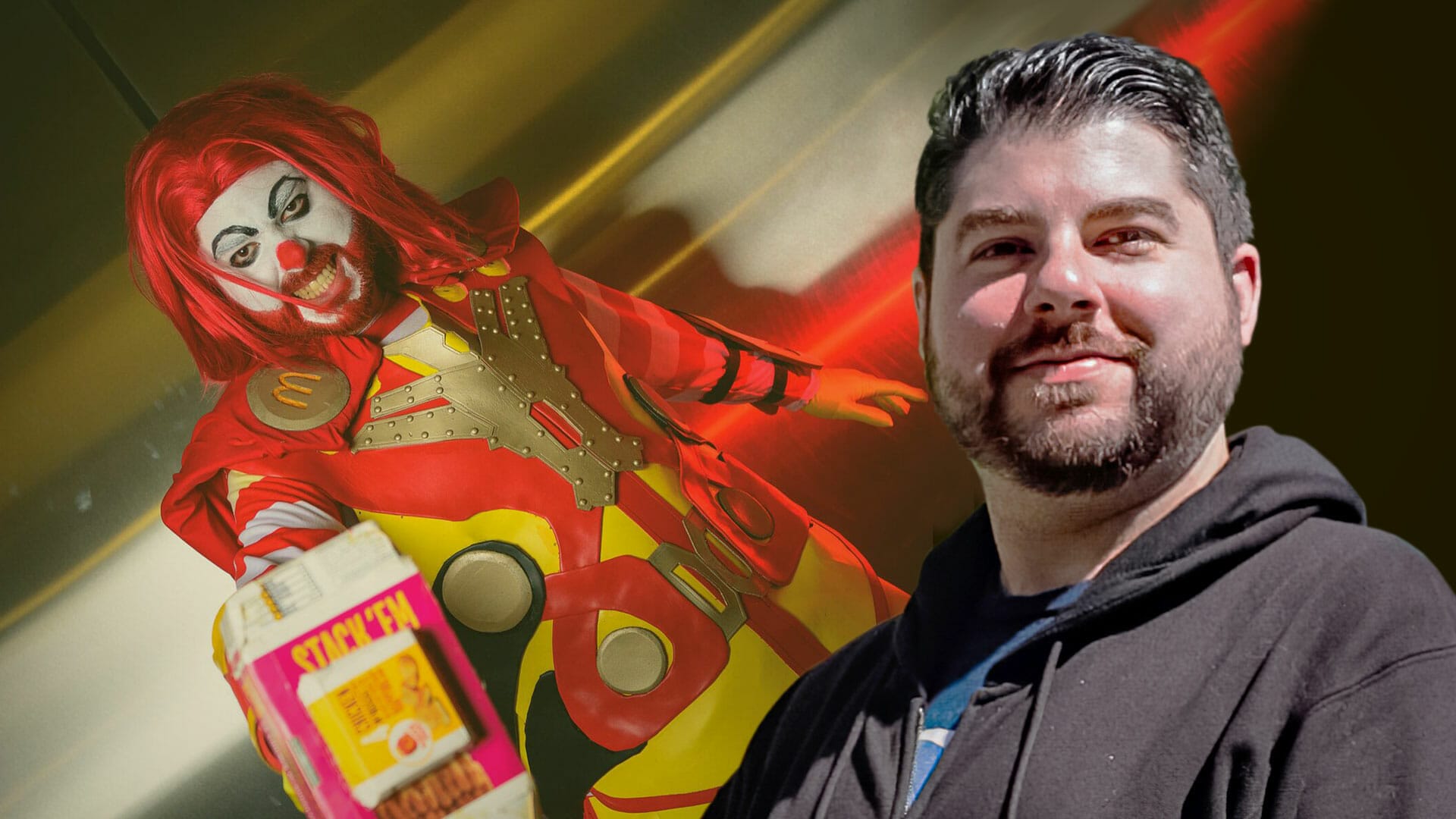 A man in a mcdonald's costume is standing next to a red mcdonald's.