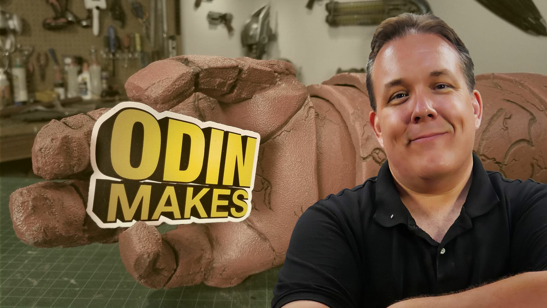 A man standing in front of a sign that says Odin Makes Mandalorian.