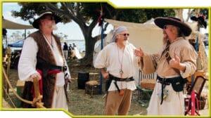 A group of men participating in Pirate Reenactment dressed in pirate clothing.