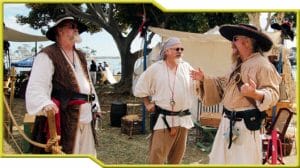 A group of men participating in Pirate Reenactment dressed in pirate clothing.